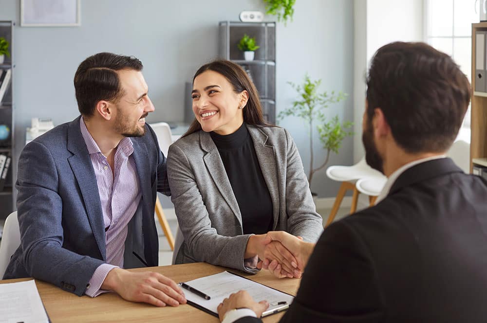 two clients handshakes with insurance broker