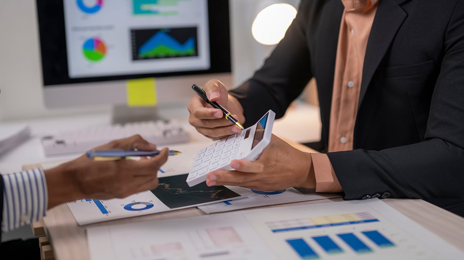 two finance managers calculating