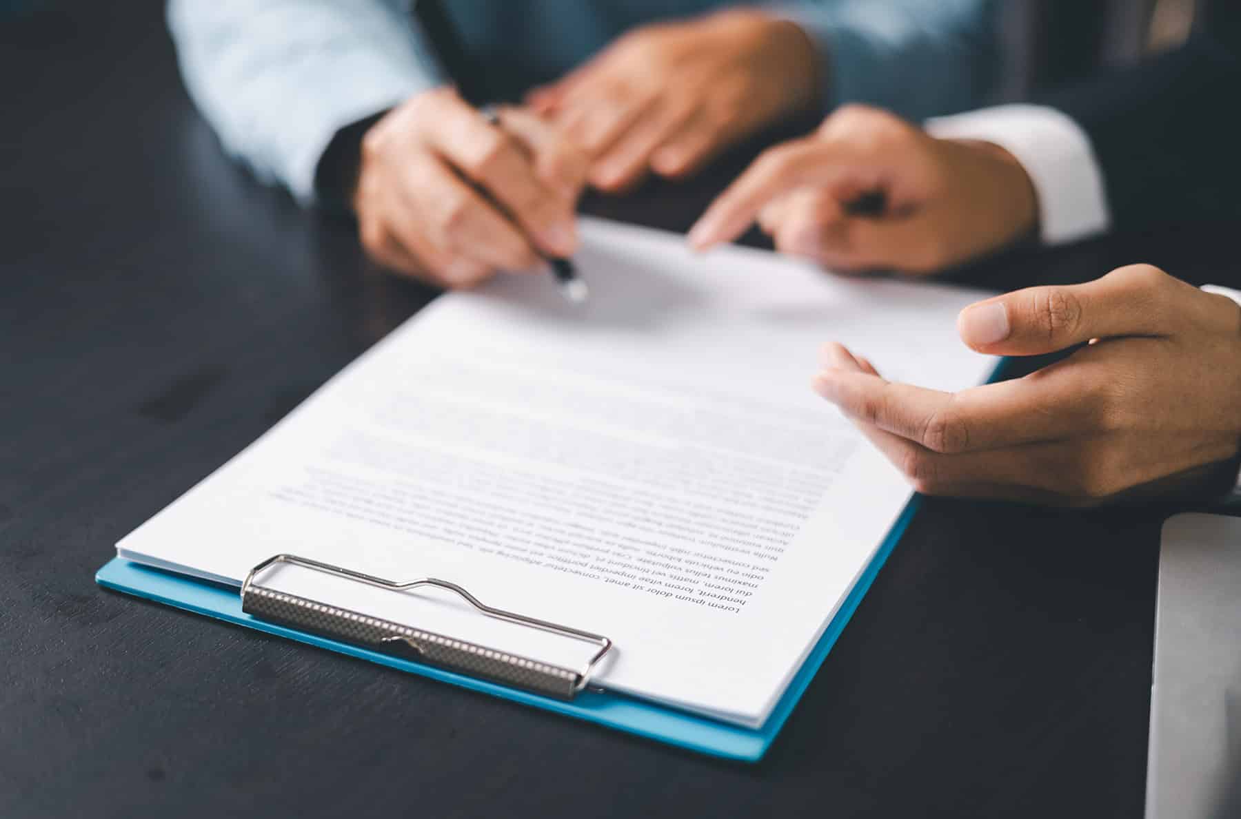two finance managers checking insurance papers