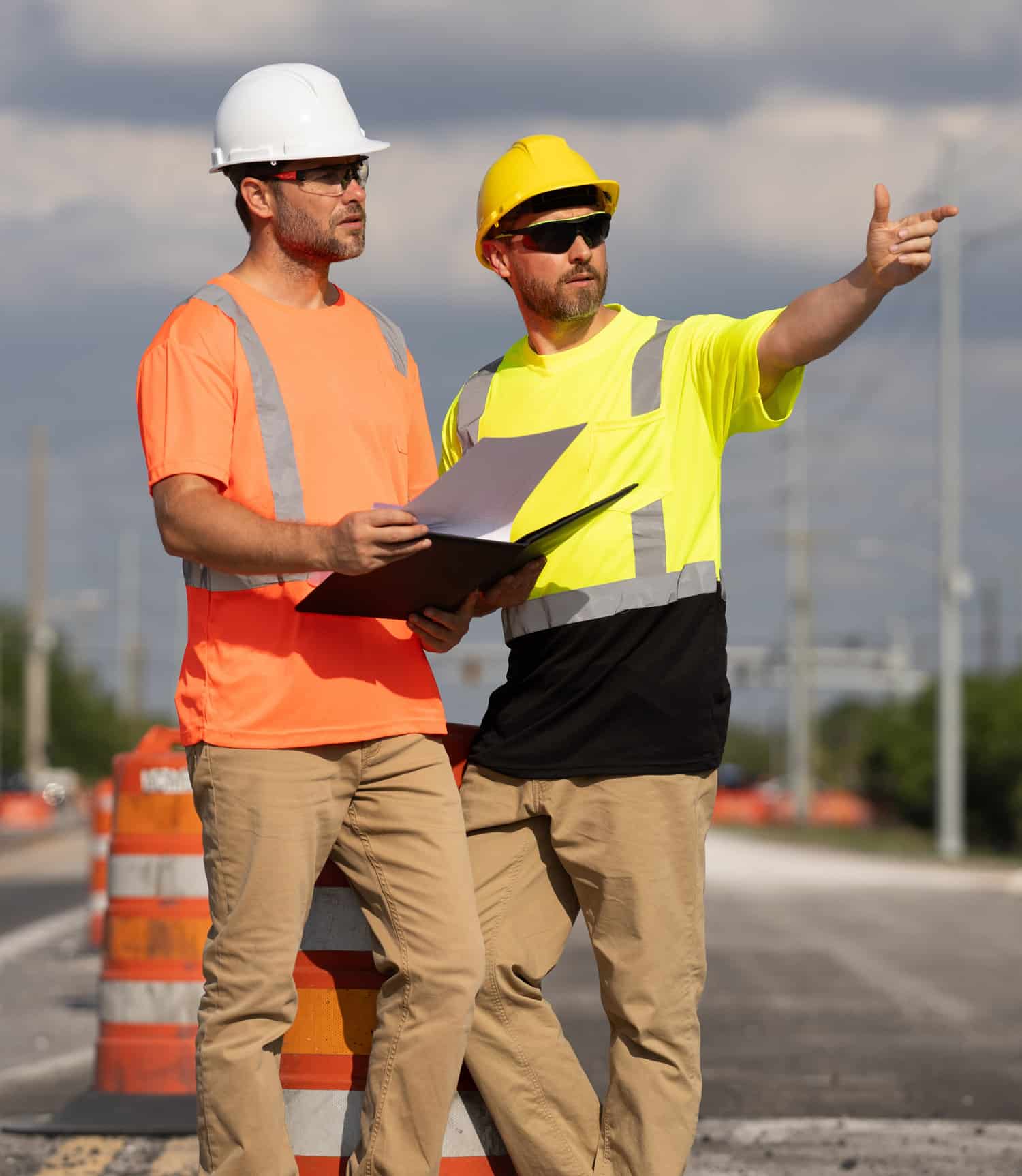 two road maintenance workers looking at clipboard