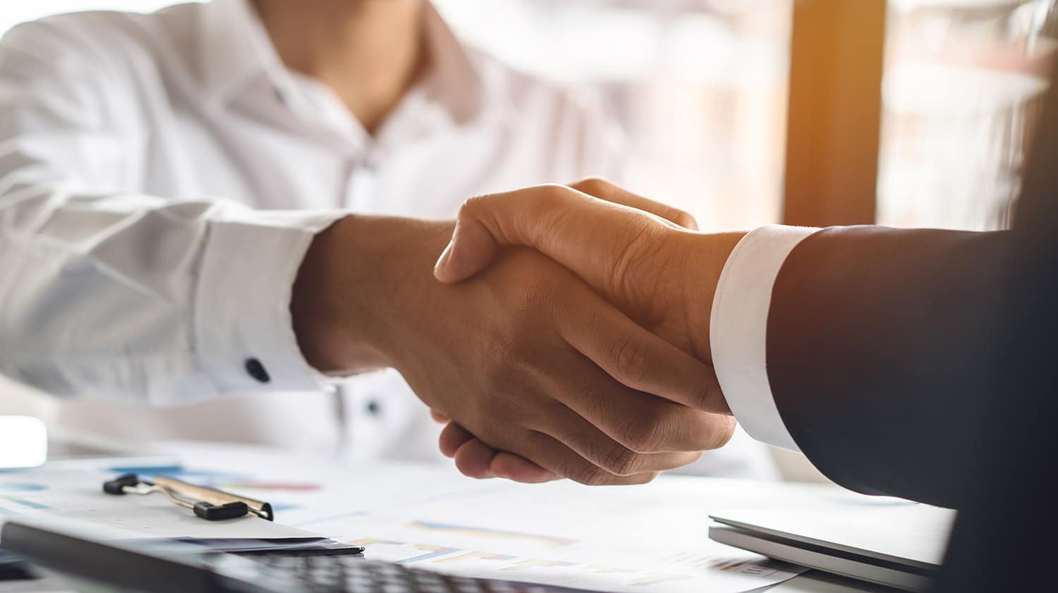 vendor shakes hands with community developer