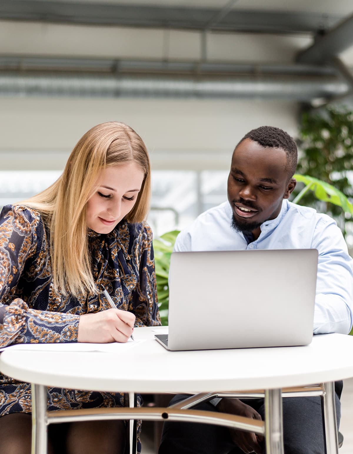 vendor writing on document talking to client