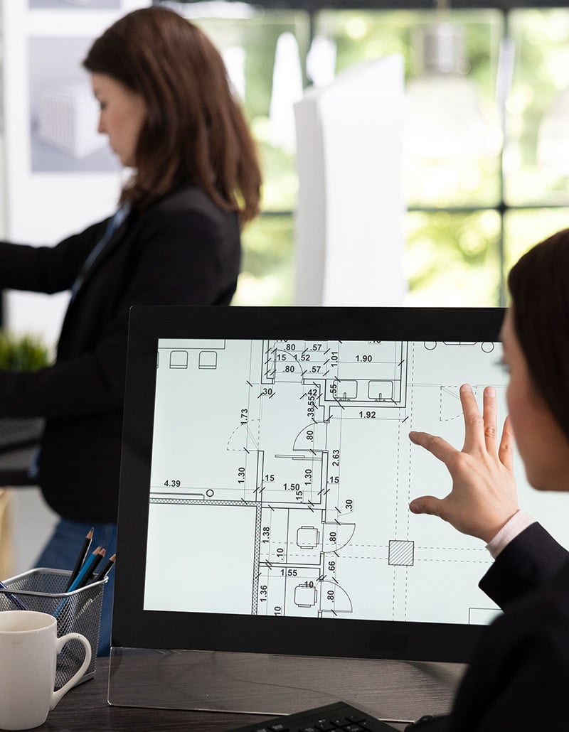 woman checking architectural plans for review