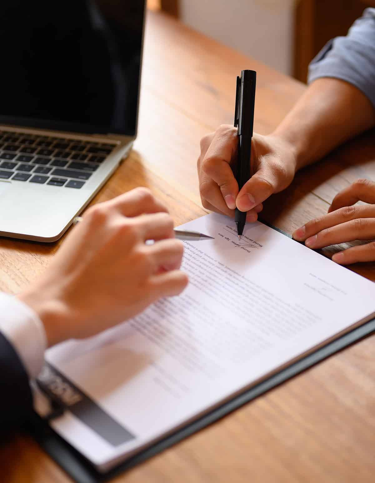 woman signing contract with client