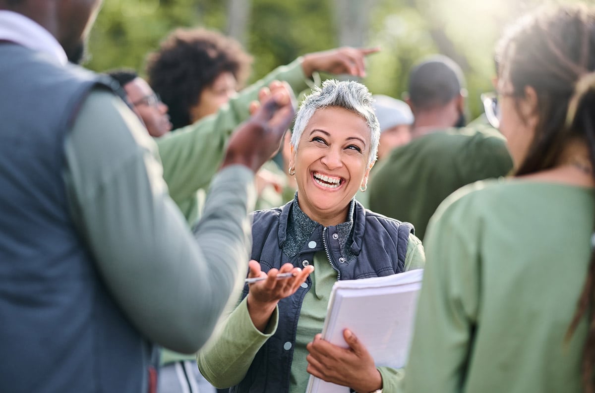 woman smiling and holding guidelines