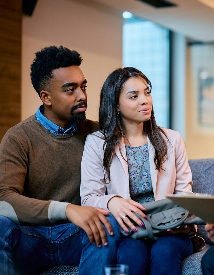 young couple talking to insurance manager